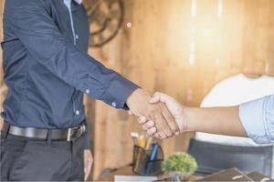 Two confident businessman shook hands during office meetings. photo