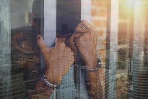 Hand of the prisoner on a steel lattice close up photo