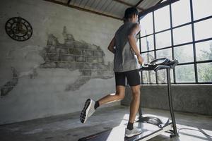 A man walking and exercising on a treadmill. photo