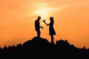 Happy young couple together against beautiful sunset. Freedom, photo