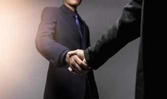 Two confident businessman shook hands during office meetings. photo