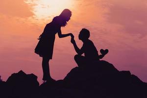 Happy young couple together against beautiful sunset. Freedom, photo