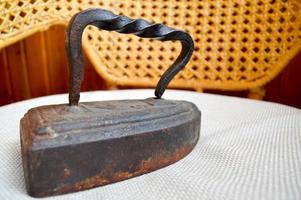 A very old cast iron on charcoal. Antique iron. photo