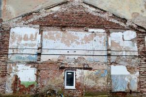 A trail from the ruined building on a brick wall. Imprint of the old demolished building on the wall of another house. photo