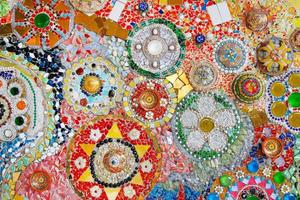 Colorful wall decorated with multicolor stone, gravel and gem for background at Wat Phra That Pha Son Kaew. Abstract of art design with broken tile for wallpaper. photo