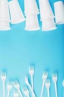 Dishes made of white plastic on a blue background. photo