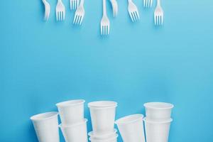 Dishes made of white plastic on a blue background. photo