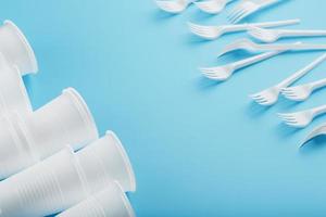 Dishes made of white plastic on a blue background. photo