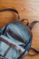 An empty handmade genuine leather backpack is open for things. photo