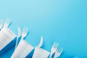 Dishes made of white plastic on a blue background. photo