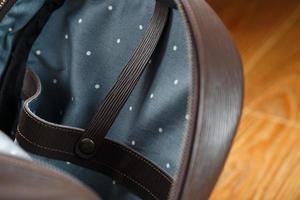 An empty handmade genuine leather backpack is open for things. photo