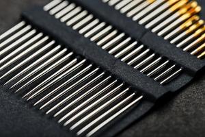 A set of sewing needles on a black background. photo