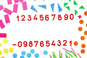 Multicolored plastic figures and numbers on a white background. Educational games for children. Math and calculation skills. photo