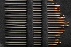 A set of sewing needles on a black background. photo