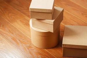 Cardboard mail boxes on the wooden floor of different shapes. photo