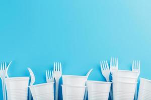 Dishes made of white plastic on a blue background. photo