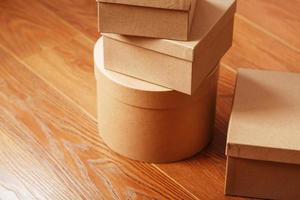 Cardboard mail boxes on the wooden floor of different shapes. photo