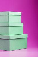 Boxes on a pink background in the form of a pyramid. photo