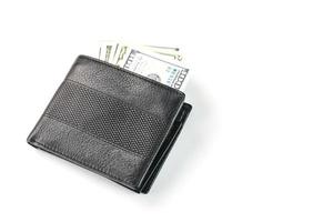 Black wallet with genuine leather dollars on an isolated white background. photo