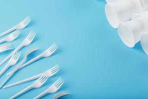 Dishes made of white plastic on a blue background. photo