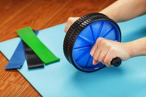 Sports blue roll for training the abs in the hands. photo