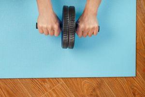 Sports blue roll for training the abs in the hands. photo