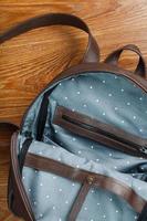 An empty handmade genuine leather backpack is open for things. photo