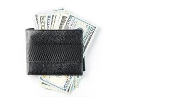 Black wallet with genuine leather dollars on an isolated white background. photo