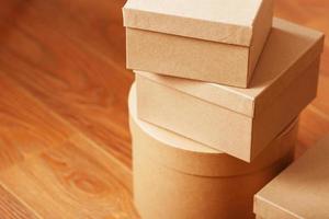 Boxes of parcels on a wooden background, free space. photo