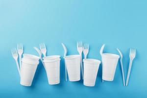 Dishes made of white plastic on a blue background. photo