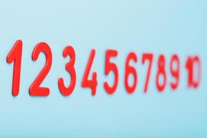 Red numbers on a blue background in a row from one to ten. photo