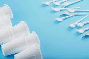 Dishes made of white plastic on a blue background. photo