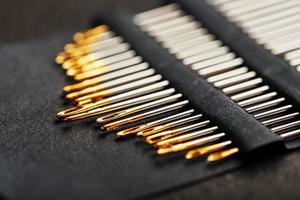 A set of sewing needles on a black background. photo