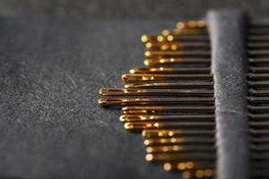 A set of sewing needles on a black background. photo