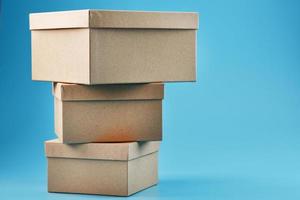 Cardboard boxes in the shape of a pyramid on a blue background. photo