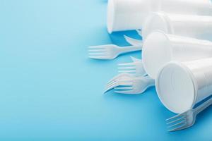 Dishes made of white plastic on a blue background. photo