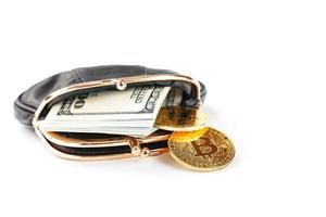 An open black wallet with money, dollars and bitcoin coins on a white background. photo