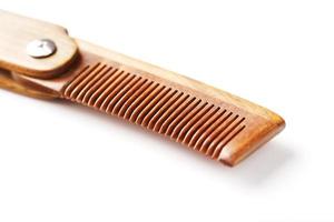 Sandalwood comb on a white background. Hair care. photo