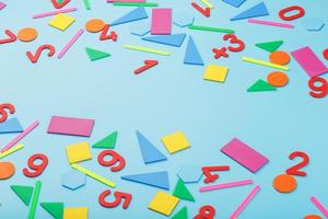 Colorful figures and numbers for children on a blue background. A tool for developing children's thinking. photo