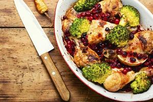 Baked chicken legs with broccoli. photo