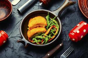 Chicken cutlets and vegetable garnish. photo