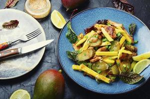 Light salad with chicken, mango and herbs. photo