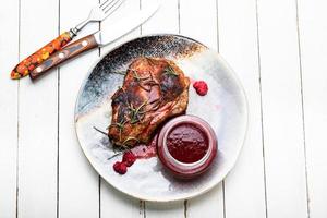 Fried steak with raspberry sauce photo