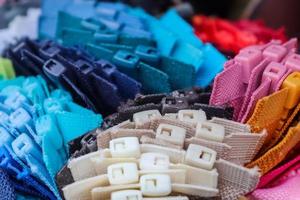 Samples of cloth and fabrics in different colors found at a fabrics market photo