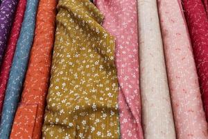 Samples of cloth and fabrics in different colors found at a fabrics market photo