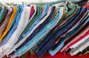 Samples of cloth and fabrics in different colors found at a fabrics market photo