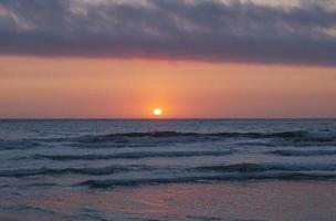 Coastal Clouds and Reflections at Sunset photo