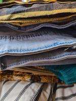 a neatly arranged pile of various neat clothes and pants after ironing. photo