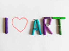 phrase I love art made by colorful pastel crayons on a white background photo