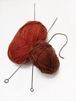wool for knitting and knitting needles on a white background photo